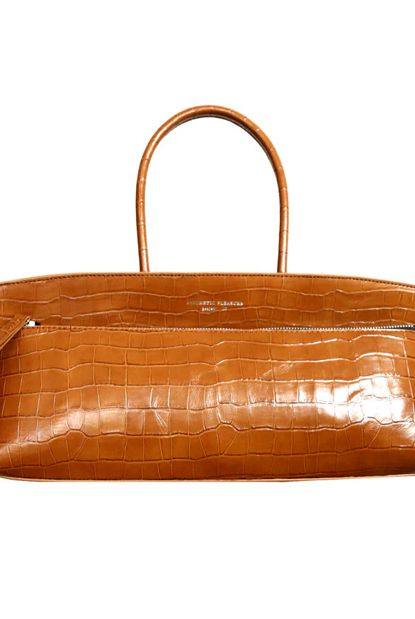 Brown alligator embossed leather baguette bag with a zip closure and tubular handles by Aesthetic Pleasure.