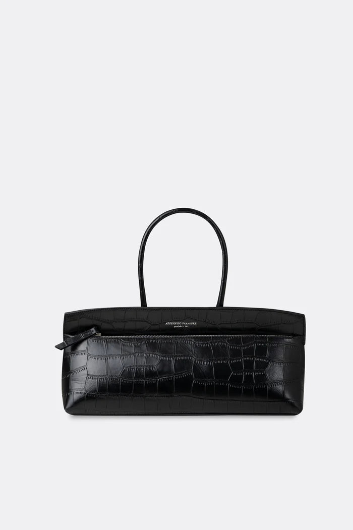 Black baguette handbag with crocodile texture by Aesthetic Pleasure on a white background