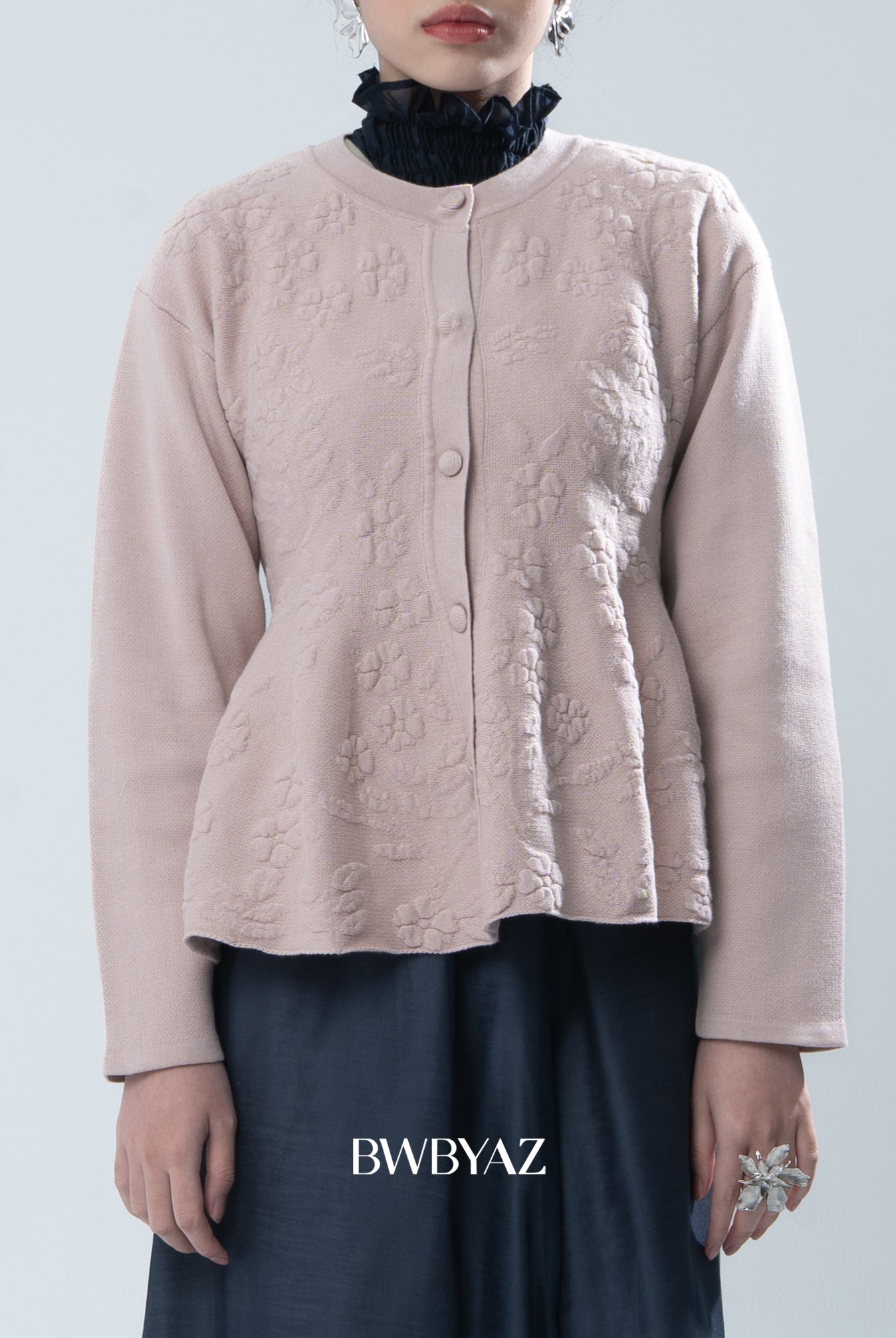 Light pink textured knit cardigan worn by a person on a light gray background, with 'BWBYAZ' branding.