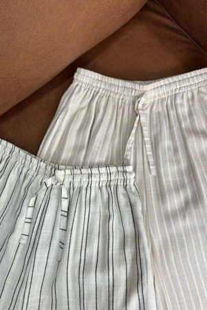 Striped pants by Renaette on a brown surface