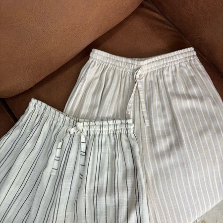 Striped pants by Renaette on a brown surface