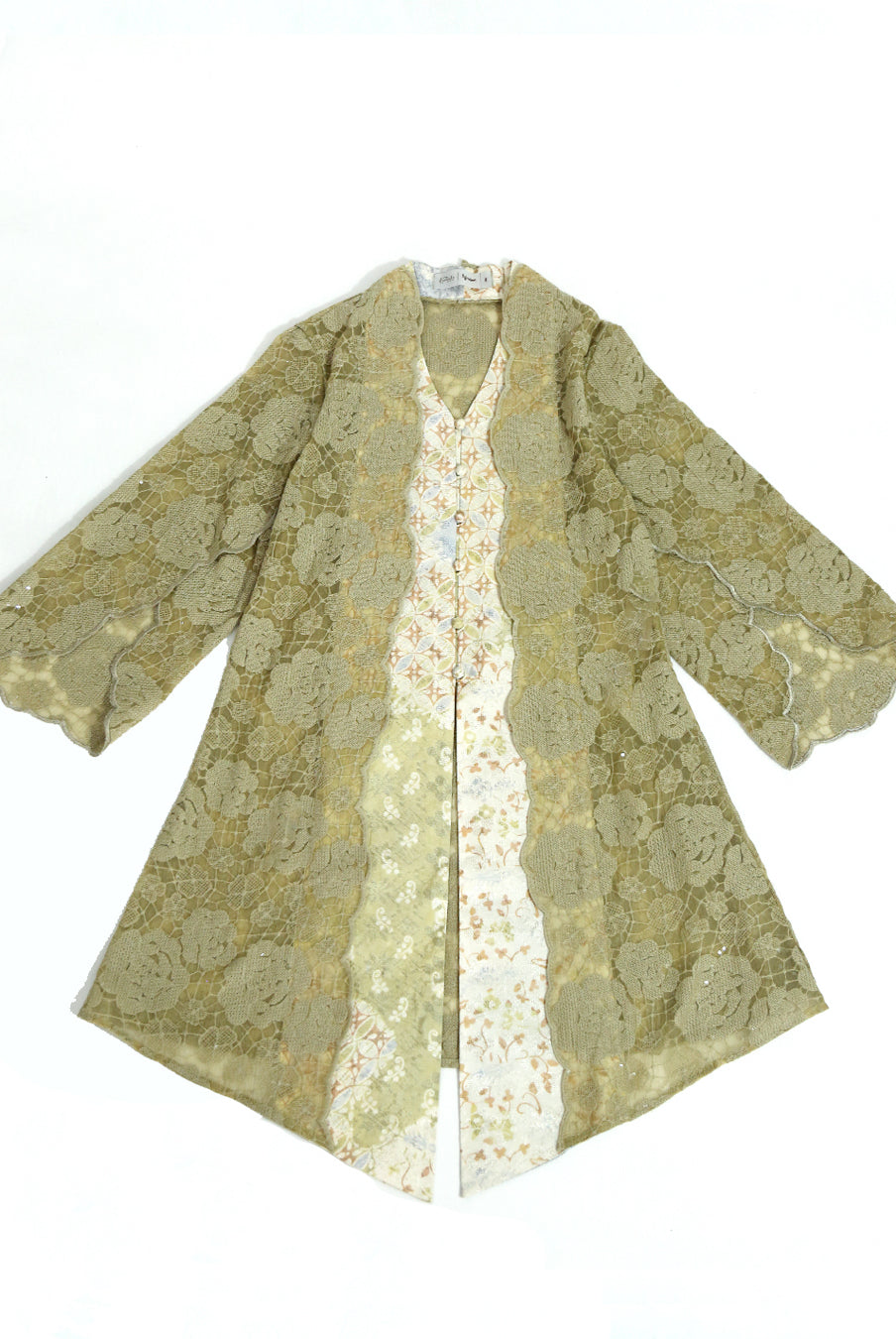A beige and gold floral embroidered organza tunic by Kartinis Label with batik details, featuring a front opening with buttons and beadings, displayed on a mannequin.