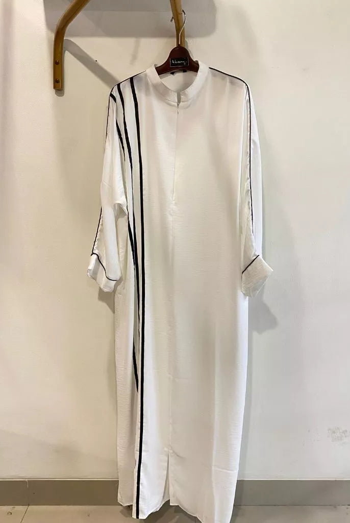 A white dress by Abame with black vertical stripes.