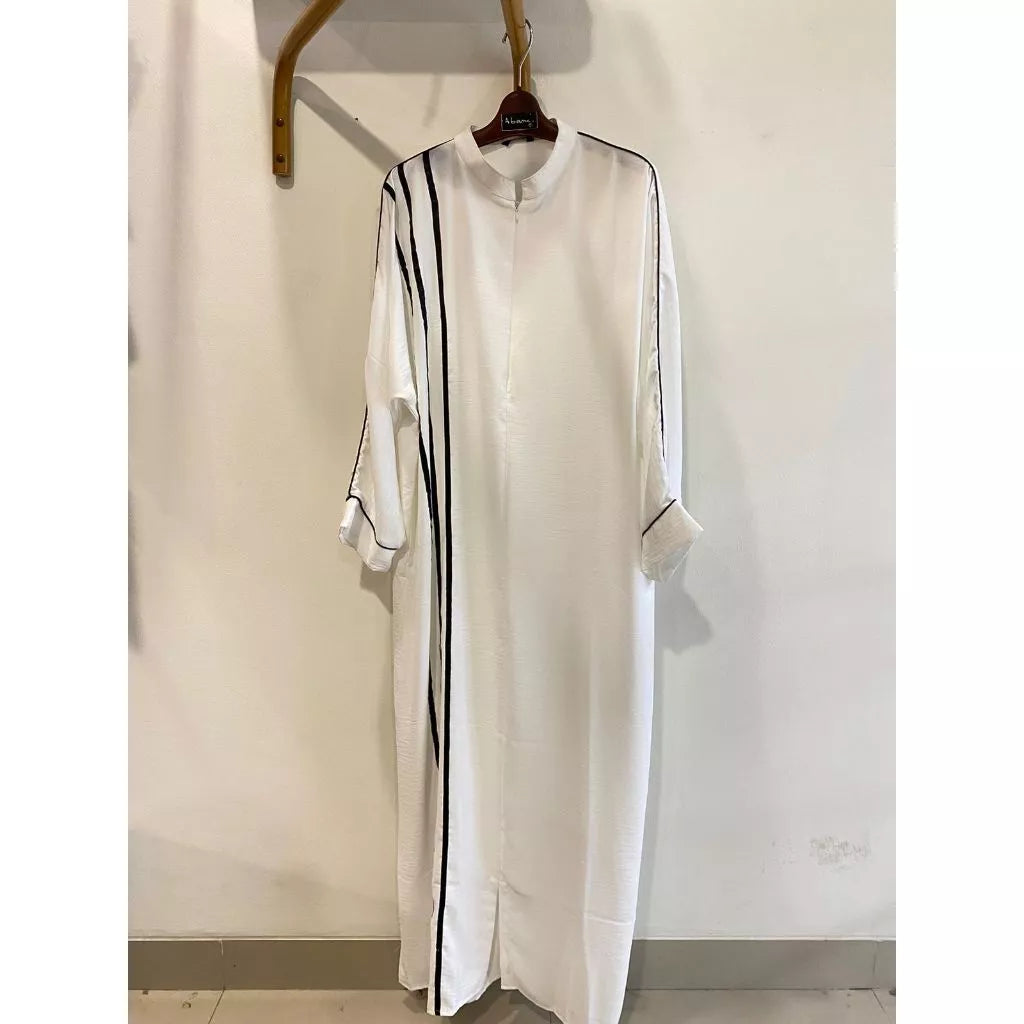 A white dress by Abame with black vertical stripes.