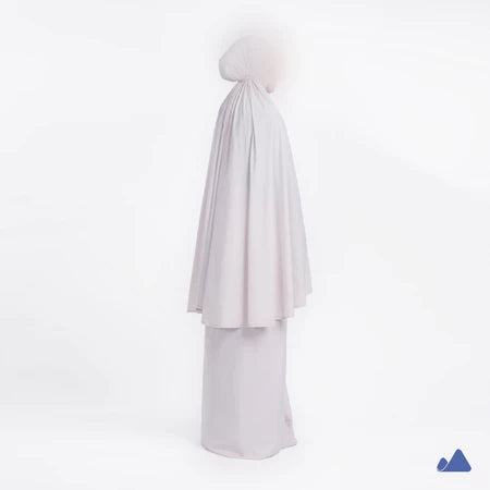 Misty grey prayer hijab with a draped design from Muhajir Project on a white background