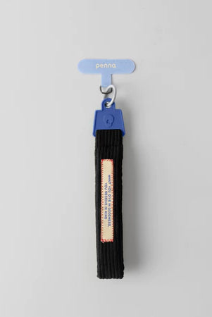 Black keychain strap strap with a blue clip from Muhajir Project on a gray background
