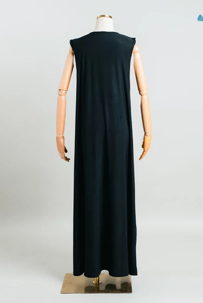 Rear view of black sleeveless dress from Muhajir Projecton a mannequin against a white background