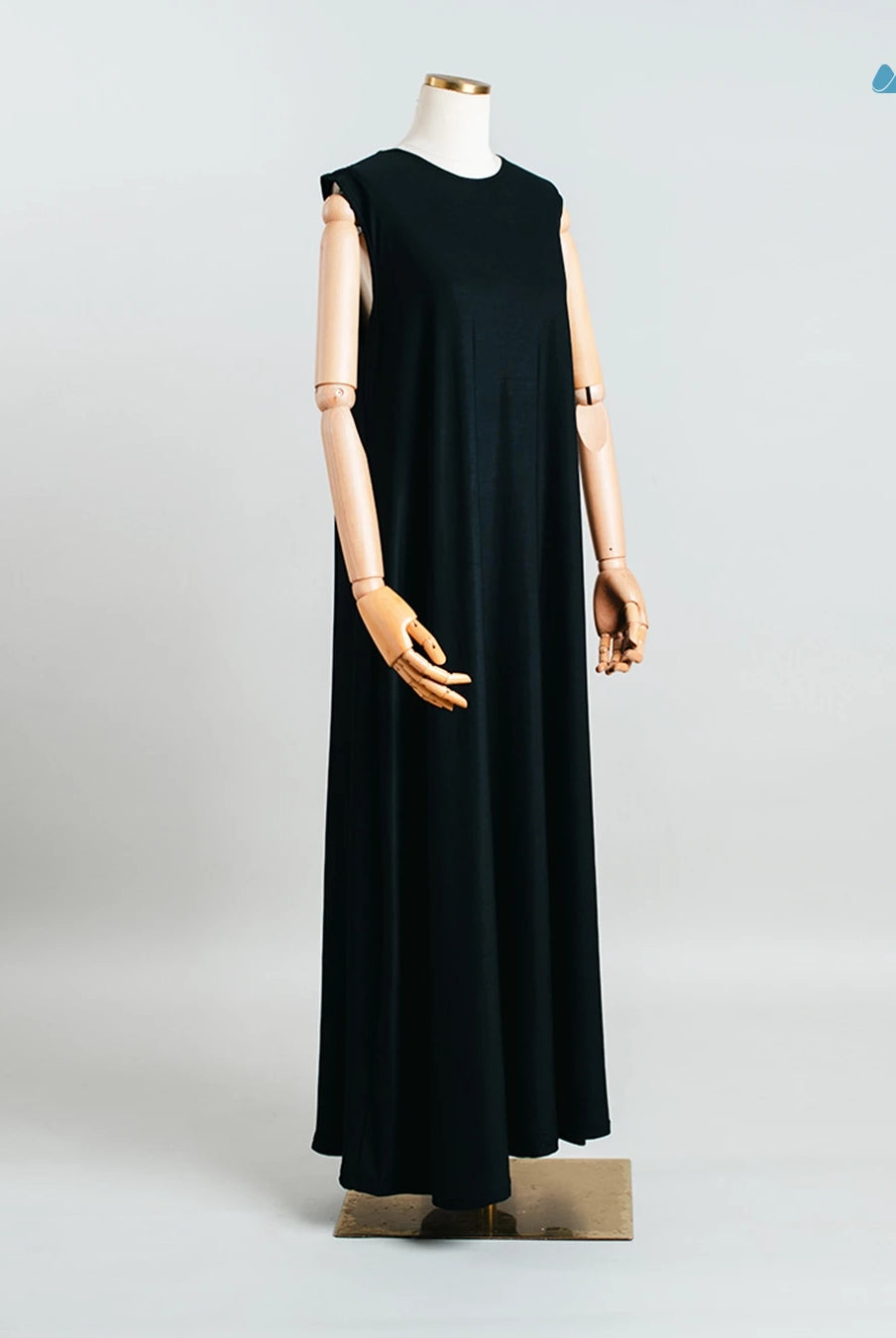 Black sleeveless dress from Muhajir Project on a mannequin against a light gray background