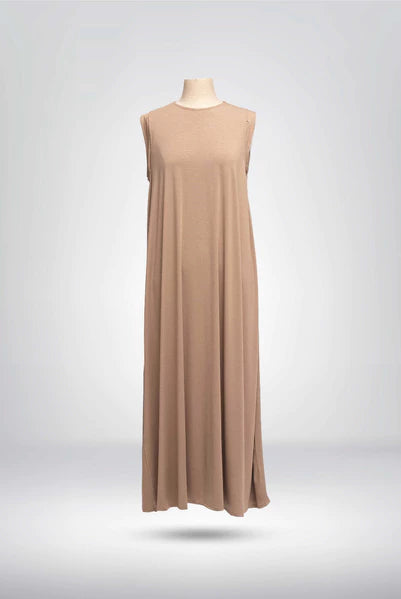 Front view of light brown sleeveless dress from Muhajir Project on a mannequin against a gray background