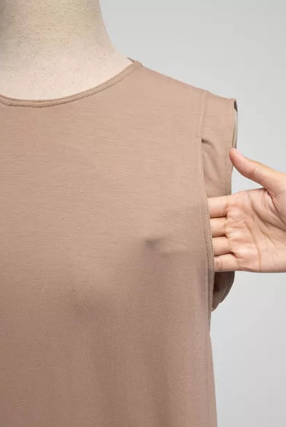 Light brown sleeveless top on a mannequin with a hand pointing to it, against a gray background