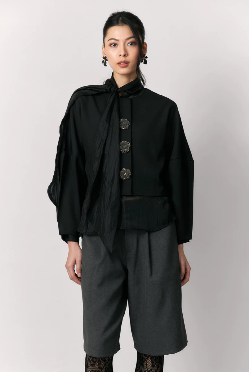 Person wearing a black shirt by Studio Tui with a white background