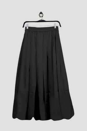 Black skirt by Maima on a hanger against a light gray background