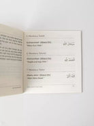 Open book with Arabic text on a white background