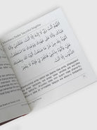 Open book with Arabic text on a white background