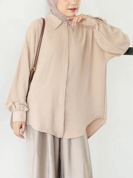 Person wearing a beige shirt by Mistyvori and hijab on a white background