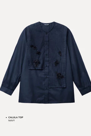 Navy blue shirt by Maima with floral embellishments on a light gray background