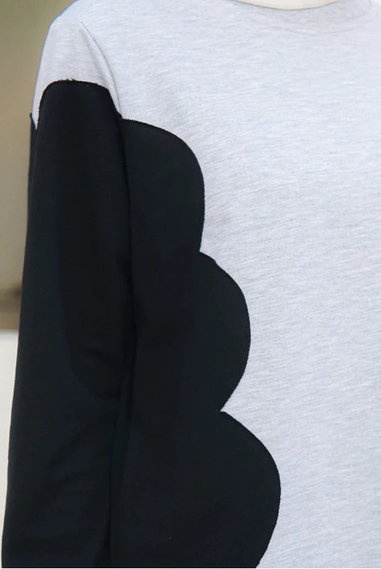 Gray sweater with black scalloped arm designs by Casa Elana on a neutral background