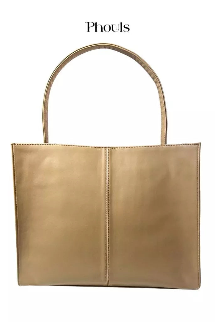 A gold-colored, synthetic leather shoulder bag with top handle and magnetic closure from Phouls.