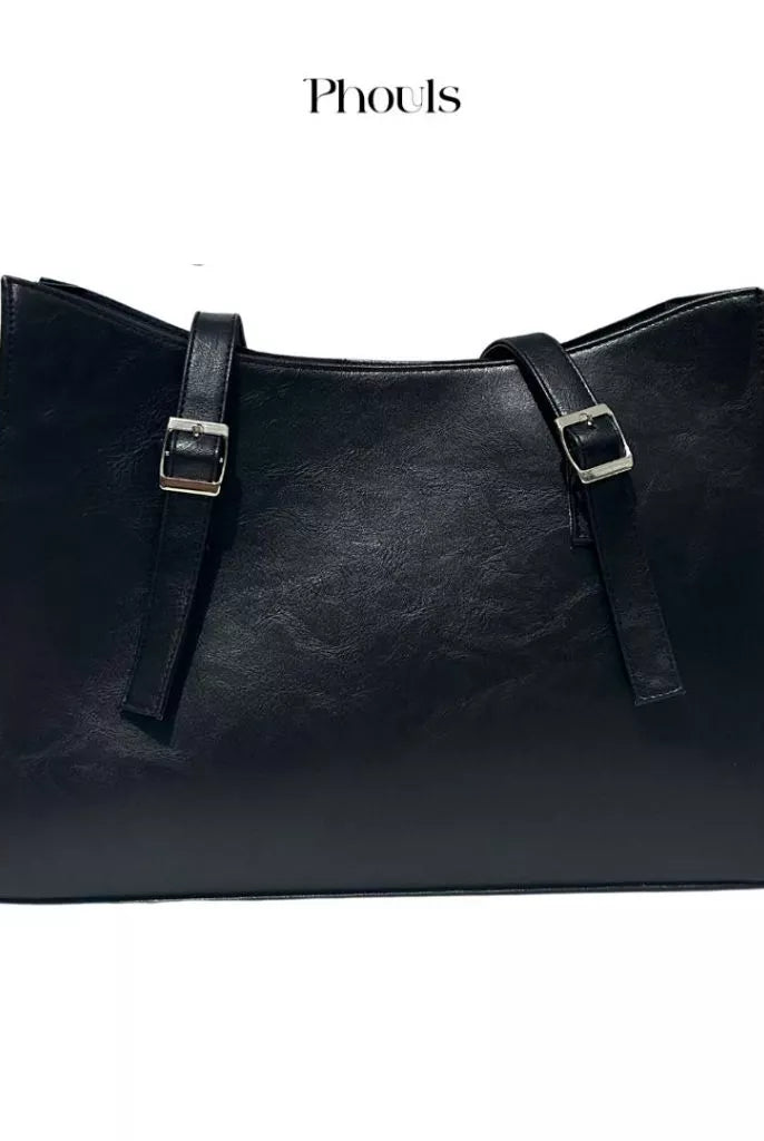 A black Cerena shoulder bag with double handles and a debossed logo of Phouls, displayed against a white background.