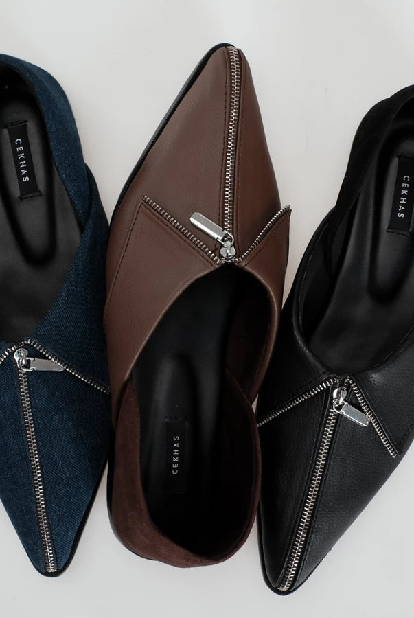 Three pointed-toe slip-on flats shoes with front zipper details, shown in navy blue, brown, and black. The shoes are arranged side-by-side on a light gray background, with the brand name 'Cekhas' visible on the insoles.