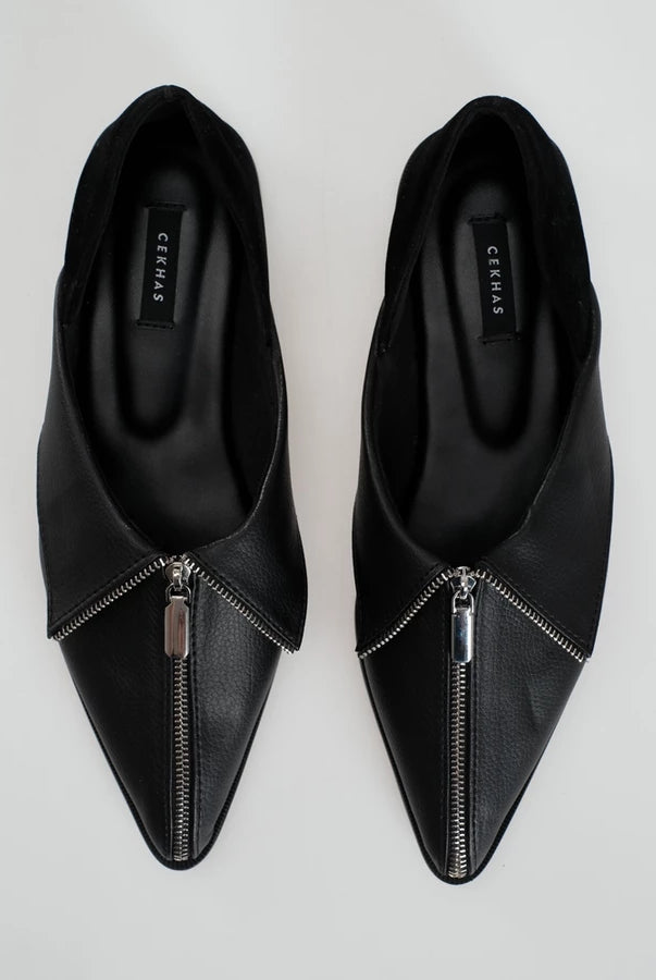 A pair of black leather pointed-toe flats shoes with a silver zipper detail running up the center front, shown from a top-down view on a light gray background. The brand name 'Cekhas' is visible on the insole.