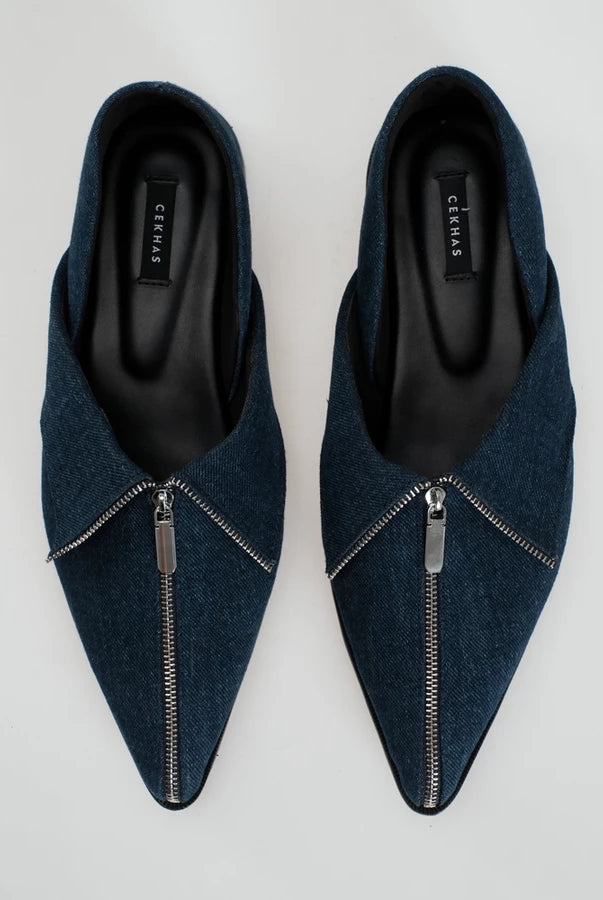 A pair of dark blue denim pointed-toe flat shoes with a silver zipper detail across the front, shown from a top-down view on a light gray background. The brand name 'Cekhas' is visible on the insole.