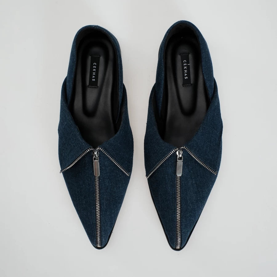 A pair of dark blue denim pointed-toe flat shoes with a silver zipper detail across the front, shown from a top-down view on a light gray background. The brand name 'Cekhas' is visible on the insole.