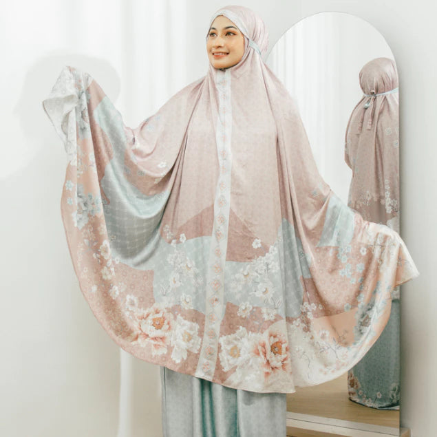 Woman wearing a prayer set by Holypeony with tosca accents in front of a mirror.
