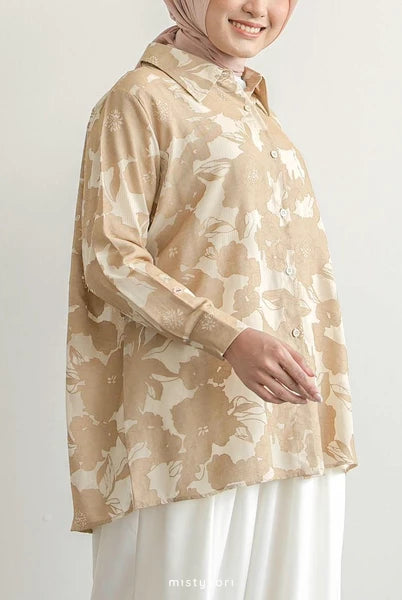 Person wearing a beige floral shirt by Mistyvori with a plain background
