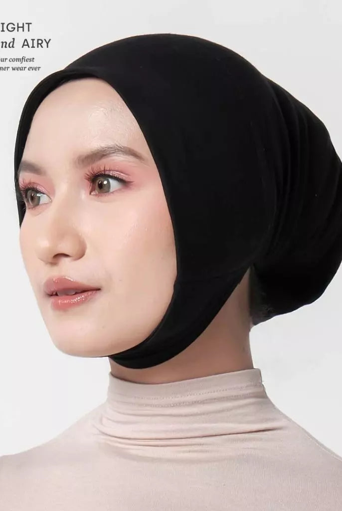 Woman wearing a black ciput dagu with 'alif' branding on a white background