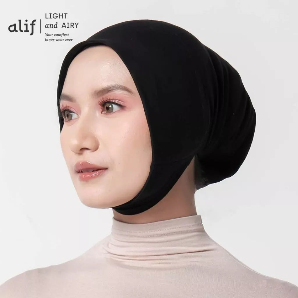 Woman wearing a black ciput dagu with 'alif' branding on a white background