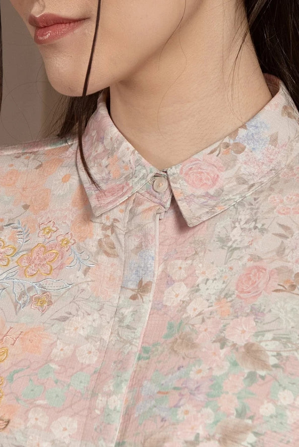 Close-up of a person wearing a floral patterned shirt by Hijabchic with a neutral background