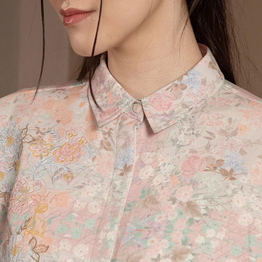 Close-up of a person wearing a floral patterned shirt by Hijabchic with a neutral background