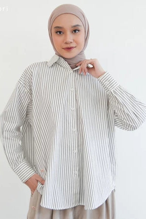 Woman wearing a grey striped shirt by Mistyvori and hijab on a white background