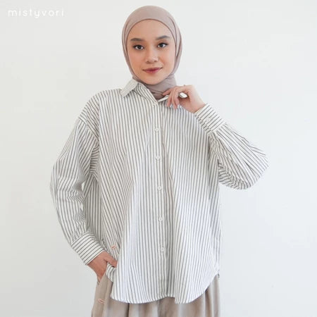 Woman wearing a grey striped shirt by Mistyvori and hijab on a white background