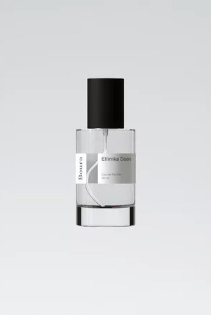 A bottle of Ellinka Doors perfume with a white label and black cap from Boura against a white background.