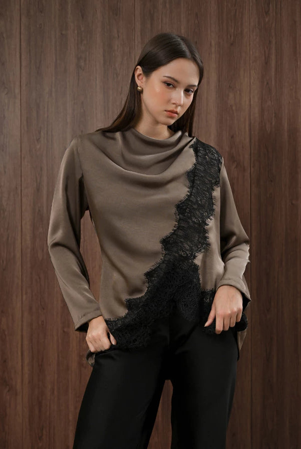 Woman wearing a brown blouse with black lace details by Kasa Heritage against a wooden background
