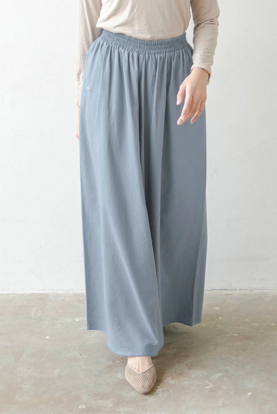 Person wearing light denim blue wide-leg pants by Mistyvori on a plain background