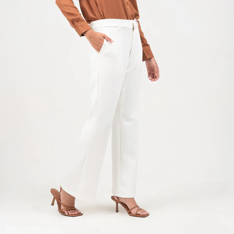 Person wearing a brown top and white flare pants from Atala Scarves on a white background