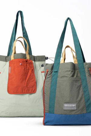Reversible tote bag with different color combinations from Muhajir Project on a white background