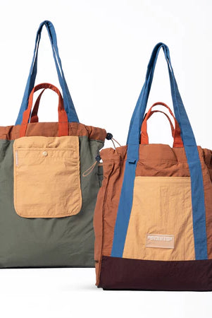 Reversible tote bag with different color combinations from Muhajir Project on a white background