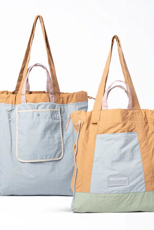 Reversible tote bag with different color combinations from Muhajir Project on a white background