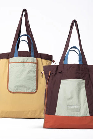 Reversible tote bag with different color combinations from Muhajir Project on a white background