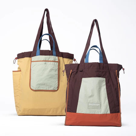 Reversible tote bag with different color combinations from Muhajir Project on a white background
