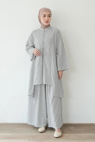 Woman wearing a gray striped outfit set by Mistyvori with a hijab against a white background