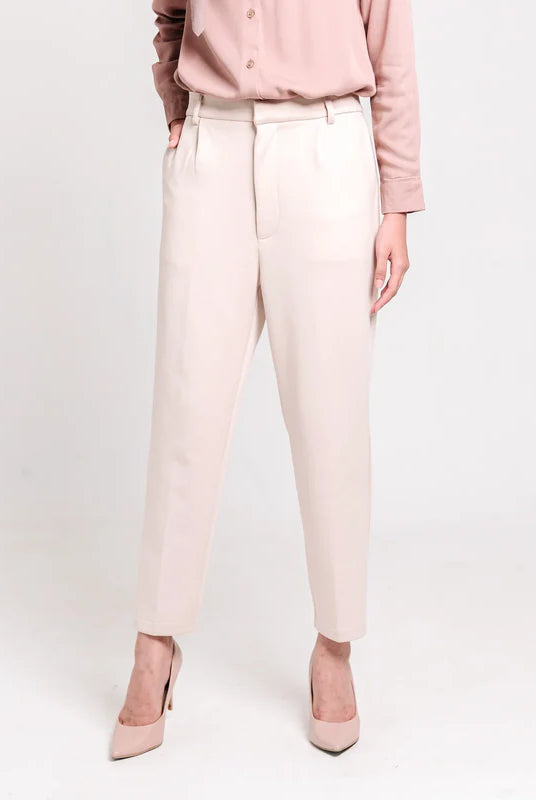 Person wearing ivory ankle pants from Atala Scarves and matching shoes on a white background