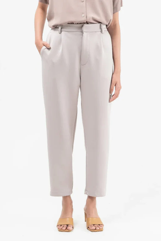 Light grey ankle pants from Atala Scarves worn by a person on a white background