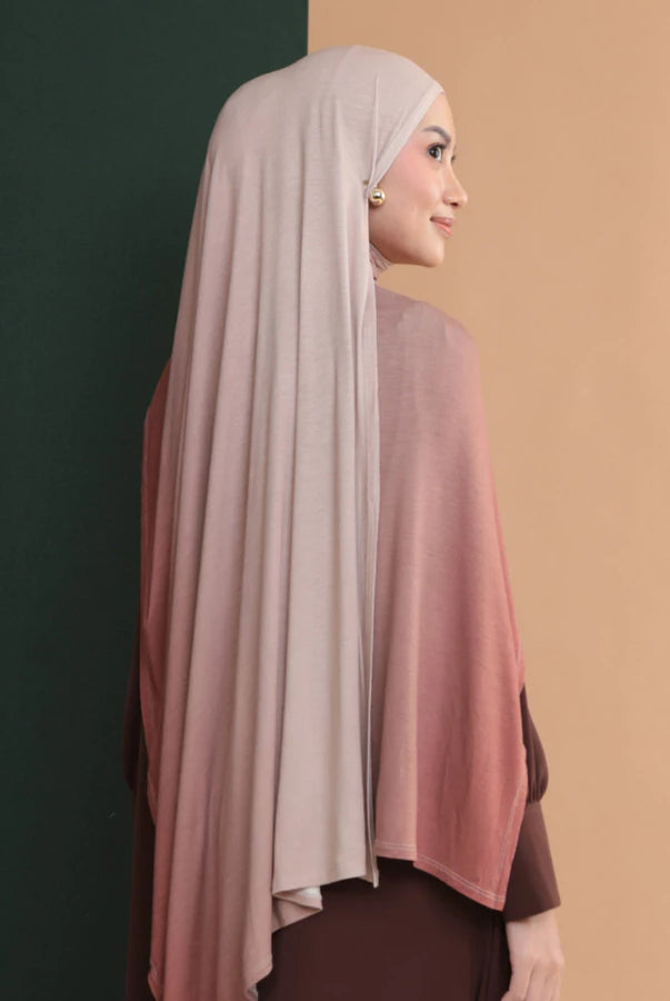 Woman wearing a hijab shawl with a gradient effect by Lozy Hijab on a two-tone background
