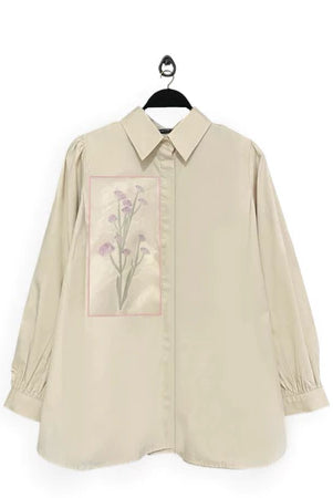 Beige shirt with floral design named Gwen Top from Maima on a white background