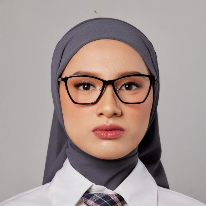A person wearing a grey hijab and a pair of square-shaped eyeglasses with black frames from HSF Eyewear.